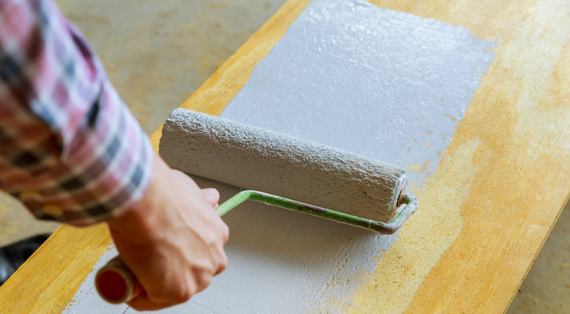 painting the wood with white paint roller House painting,paint roller